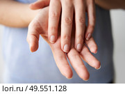 Close Up of a Woman rubbing her hands together with disinfectant . Стоковое фото, агентство Ingram Publishing / Фотобанк Лори