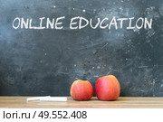 Back to school concept with two red apples and chalk. copy space on blackboard. School and online education background.. back to school. Стоковое фото, агентство Ingram Publishing / Фотобанк Лори
