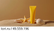 Yellow Sunscreen cream tube, starfishes and seashells on a sand top view. Cosmetic mockup. Sunblock lotion on sandy beach background. Summer vacation care concept, sun screen product, spf uv protect. Стоковое AI-изображение, AI-художник Марина Демидюк / Фотобанк Лори