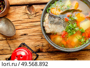 Plate with fish soup on a wooden retro table.Homemade fish soup. Fish soup or chowder. Стоковое фото, агентство Ingram Publishing / Фотобанк Лори