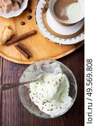 porcelain cup of coffee with pistachio ice cream  served  at table. life style concept. Стоковое фото, агентство Ingram Publishing / Фотобанк Лори
