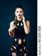 white girl modell on a dark background in a dress made of cut stripes of black fabric. Стоковое фото, агентство Ingram Publishing / Фотобанк Лори