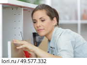 a woman fitting a furniture. Стоковое фото, агентство Ingram Publishing / Фотобанк Лори