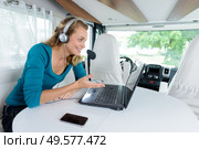 pretty smiling blond-haired using her new laptop in van. Стоковое фото, агентство Ingram Publishing / Фотобанк Лори