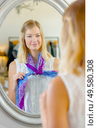 girl trying scarf in front of mirror. Стоковое фото, агентство Ingram Publishing / Фотобанк Лори