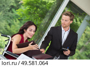 attractive disabled woman ordering to the waiter at the restaurant. Стоковое фото, агентство Ingram Publishing / Фотобанк Лори