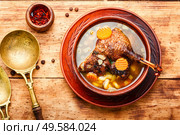 Goose soup with vegetables and pasta. A bowl of duck soup on wooden table. Appetizing goose soup. Стоковое фото, агентство Ingram Publishing / Фотобанк Лори