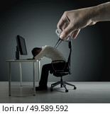Conceptual picture of an exhausred office worker being winded up. Стоковое фото, агентство Ingram Publishing / Фотобанк Лори