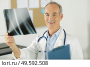 a senior doctor holding xray. Стоковое фото, агентство Ingram Publishing / Фотобанк Лори