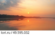 Sunrise spring melting river flood aerial panorama. Overflow water at springtime. Rural April landscape. Meadows covered by water. Morning flood-land near Neman, Belarus. . Стоковое фото, агентство Ingram Publishing / Фотобанк Лори