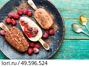 Popsicle ice cream with chocolate and cherry.Ice cream sticks. Chocolate ice cream on a stick. Стоковое фото, агентство Ingram Publishing / Фотобанк Лори