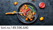 Sliced beef steak roasted with kumquat,rosemary and spices.American barbecue. Juicy beef steak with kumquat. Стоковое фото, агентство Ingram Publishing / Фотобанк Лори
