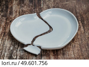 Broken Heart-Shaped Plate Symbolizes Lost Love and Emotional Fragility in Conceptual Art. Стоковое фото, фотограф Aleksandr Golubev / Фотобанк Лори