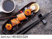 sushi roll set served  at black tray at grey table. flat lay . Стоковое фото, агентство Ingram Publishing / Фотобанк Лори