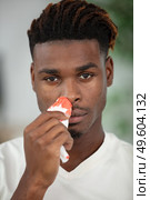 young man touching his bleeding nose. Стоковое фото, агентство Ingram Publishing / Фотобанк Лори