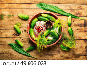 Salted homemade cucumbers.Cooking process.Canned gherkin.Marinated cucumbers old wooden surface. Raw cucumbers and ingredients for cooking pickled cucumbers. Стоковое фото, агентство Ingram Publishing / Фотобанк Лори