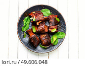 Tasty BBQ beef ribs seasoned with spicy sauce. Roasted beef brisket on the ribs,white background. Стоковое фото, агентство Ingram Publishing / Фотобанк Лори
