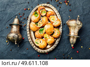 Edible snails stuffed with green butter, French delicacies. French snail dish. Стоковое фото, агентство Ingram Publishing / Фотобанк Лори