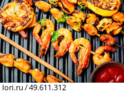 Kebab shrimps fried on a wooden stick.Grilled scampi. Grilled shrimp on a skewer. Стоковое фото, агентство Ingram Publishing / Фотобанк Лори