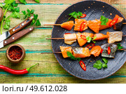 Kebabs from dried and salmon on wooden skewers.Delicious smoked fish. Dried fish salmon. Стоковое фото, агентство Ingram Publishing / Фотобанк Лори