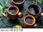 Cup of herbal tea on the table. Ivan tea or fireweed.Herbal medicine. Aromatic fireweed tea. Стоковое фото, агентство Ingram Publishing / Фотобанк Лори