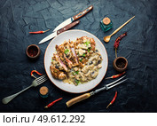 Turkey meat grilled in cheese breading with mushroom sauce. Turkey schnitzel with fried mushrooms. Стоковое фото, агентство Ingram Publishing / Фотобанк Лори