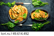 Unleavened dough pie stuffed with fresh herbs. Qutabs or kutab. Azeyrbajan food. Azerbaijani qutab with greens and cheese. Стоковое фото, агентство Ingram Publishing / Фотобанк Лори