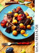 Delicious beef ribs roasted in plums and pears.Meat ribs in fruit. Beef ribs with plums and pears sauce. Стоковое фото, агентство Ingram Publishing / Фотобанк Лори