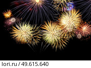 Fireworks colorful explosions on black, festive christmas background. Fireworks explosions on black. Стоковое фото, агентство Ingram Publishing / Фотобанк Лори