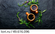 Cup of herbal tea on the table. Ivan tea or fireweed.Willow-herb.Copy space. Aromatic fireweed tea. Стоковое фото, агентство Ingram Publishing / Фотобанк Лори