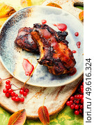 Delicious pork steak with berry sauce. Grilled pork with viburnum. Стоковое фото, агентство Ingram Publishing / Фотобанк Лори