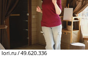 Brunette woman dance, have fun at home listens song, moves to music, feels overjoyed, celebrate good news, relish carefree life looks happy. Young adult female twirls, grooves. Lady dancing in kitchen. Стоковое видео, видеограф Марина Демидюк / Фотобанк Лори