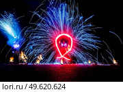 fiery pieces of a fire show against a dark sky and thunderstorms. Стоковое фото, агентство Ingram Publishing / Фотобанк Лори