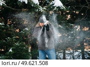 boy and girl outdoors on a winter walk playing snowballs and sledding. Стоковое фото, агентство Ingram Publishing / Фотобанк Лори