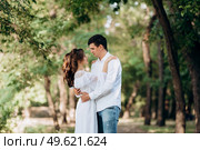guy and a girl walk along the paths of a forest park between tall trees. Стоковое фото, агентство Ingram Publishing / Фотобанк Лори