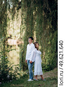 guy and a girl walk along the paths of a forest park between tall trees. Стоковое фото, агентство Ingram Publishing / Фотобанк Лори