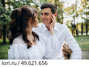 guy and a girl walk along the paths of a forest park between tall trees. Стоковое фото, агентство Ingram Publishing / Фотобанк Лори