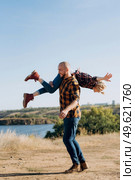 Guy and girl in caged shirts and trekking shoes on granite rocks. Стоковое фото, агентство Ingram Publishing / Фотобанк Лори