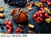 Young grape wine in a vessel. Beautiful wine flask with autumn grape wine. Stylish flask of wine. Стоковое фото, агентство Ingram Publishing / Фотобанк Лори