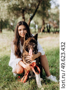 Big dog for a walk with a guy and a girl on the green prairie. Стоковое фото, агентство Ingram Publishing / Фотобанк Лори