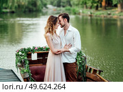 a boat trip for a guy and a girl along the canals and bays of the river overgrown with wild willows. Стоковое фото, агентство Ingram Publishing / Фотобанк Лори