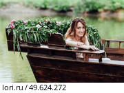 a boat trip for a guy and a girl along the canals and bays of the river overgrown with wild willows. Стоковое фото, агентство Ingram Publishing / Фотобанк Лори