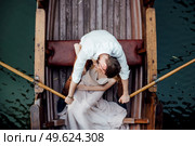 a boat trip for a guy and a girl along the canals and bays of the river overgrown with wild willows. Стоковое фото, агентство Ingram Publishing / Фотобанк Лори