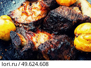 Tasty beef ribs fried with autumn quince.. Delicious beef ribs grilled with fruit. Стоковое фото, агентство Ingram Publishing / Фотобанк Лори