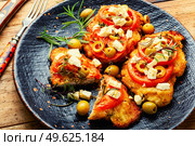 Schnitzel, breaded and fried thin layer of meat. Austrian dish. Schnitzel with olives and tomato. Стоковое фото, агентство Ingram Publishing / Фотобанк Лори
