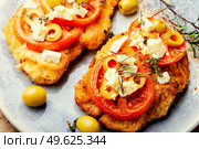 Schnitzel, breaded and fried thin layer of meat. Austrian dish, schnitzel.. Pork schnitzel with olives. Стоковое фото, агентство Ingram Publishing / Фотобанк Лори