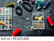 Set of sewing accessories made of buttons, threads and needles.. Sewing kit, handiwork. Стоковое фото, агентство Ingram Publishing / Фотобанк Лори