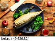 Plate with smoked mackerel fish. Delicious seafood on rural table. Tasty smoked scomber. Стоковое фото, агентство Ingram Publishing / Фотобанк Лори
