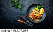 Appetizing roasted fish, fried pike perch in orange sauce.. Delicious fried fish fillets. Стоковое фото, агентство Ingram Publishing / Фотобанк Лори