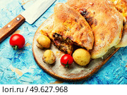 Calzone, a closed pie with vegetable filling. Dish of italian cuisine. Calzone - Italian pie, pizza. Стоковое фото, агентство Ingram Publishing / Фотобанк Лори